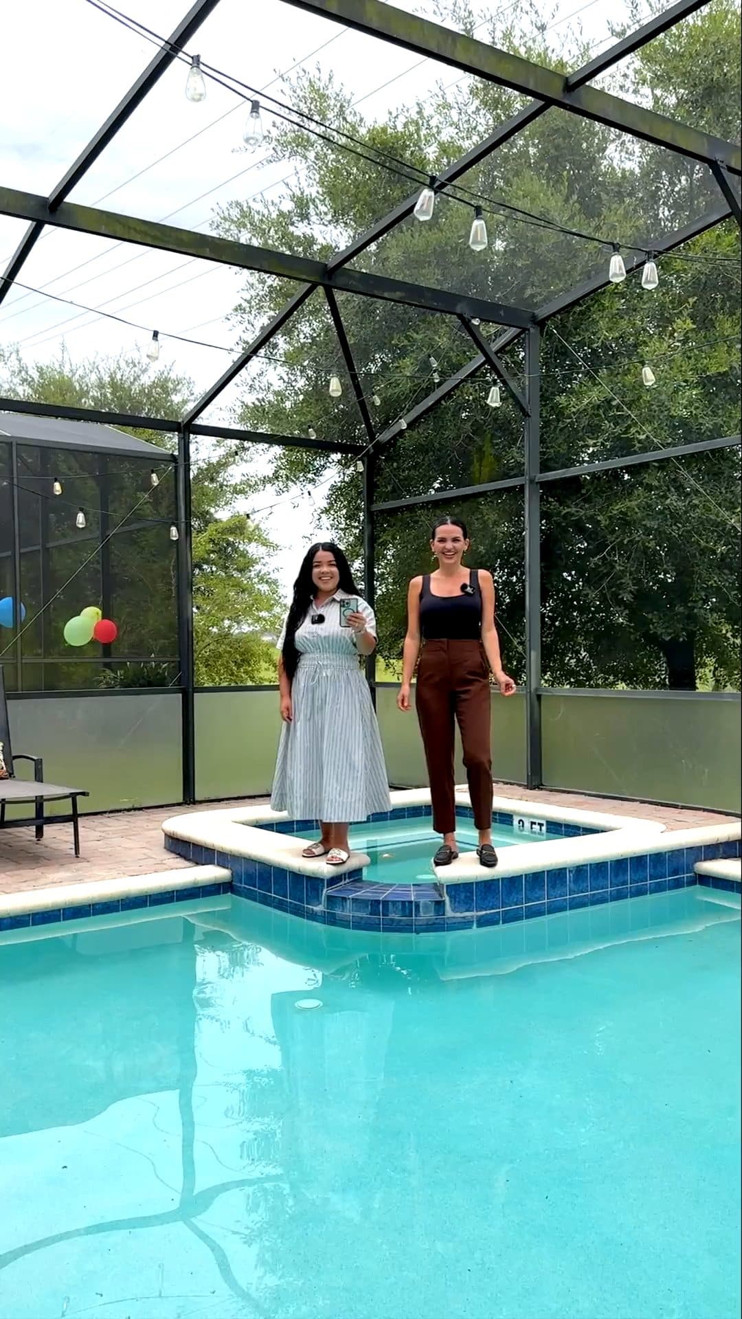 Luana and Nelly by the spa inside the screened pool enclosure at 2287 Victoria Dr, a still from the video tour