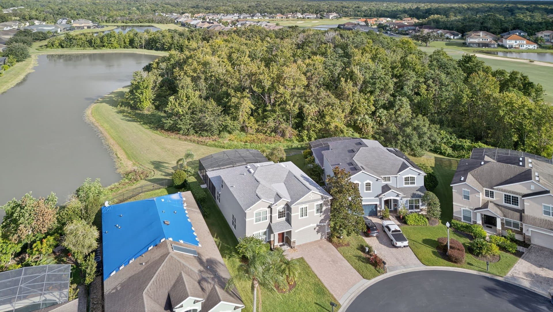 Two-story Providence homes beside a lake and a stand of trees