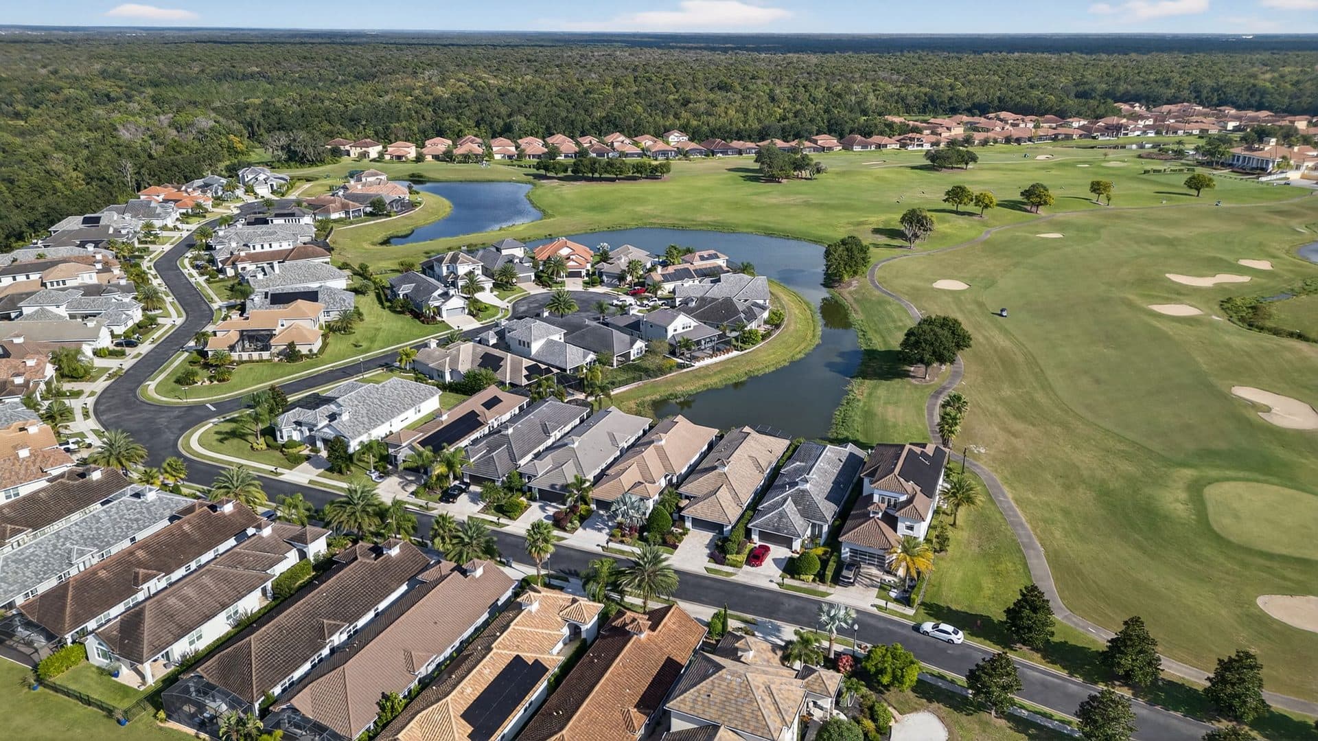 A Providence neighborhood of tile-roof homes between the golf course and a pond